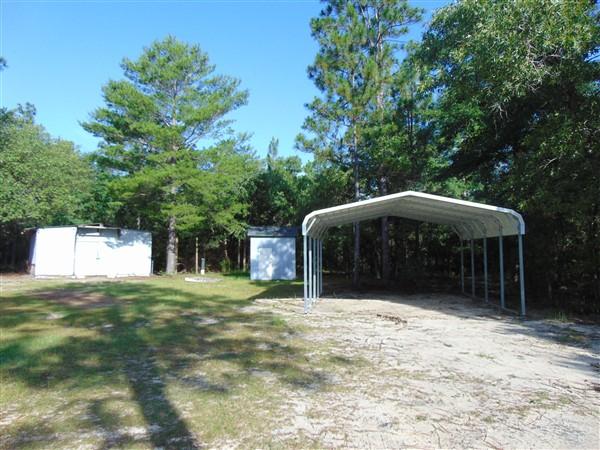 1051 Hinote Road DeFuniak Springs, FL 32433 - Photo 32 of 39 a front view of a house with a yard
