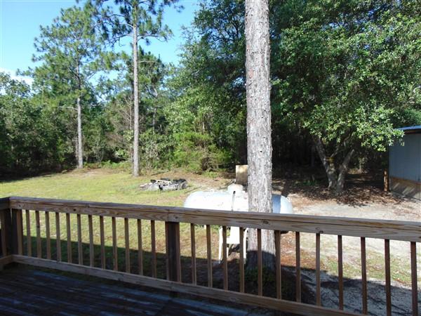 1051 Hinote Road DeFuniak Springs, FL 32433 - Photo 33 of 39 a view of backyard with a deck and wooden floor