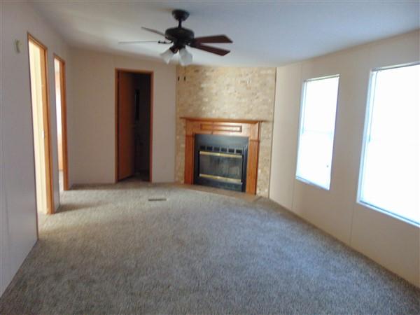 1051 Hinote Road DeFuniak Springs, FL 32433 - Photo 5 of 39 a view of empty room with fireplace and fan