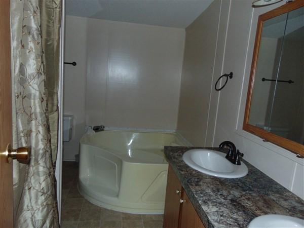 1051 Hinote Road DeFuniak Springs, FL 32433 - Photo 9 of 39 a bathroom with a granite countertop sink and a mirror
