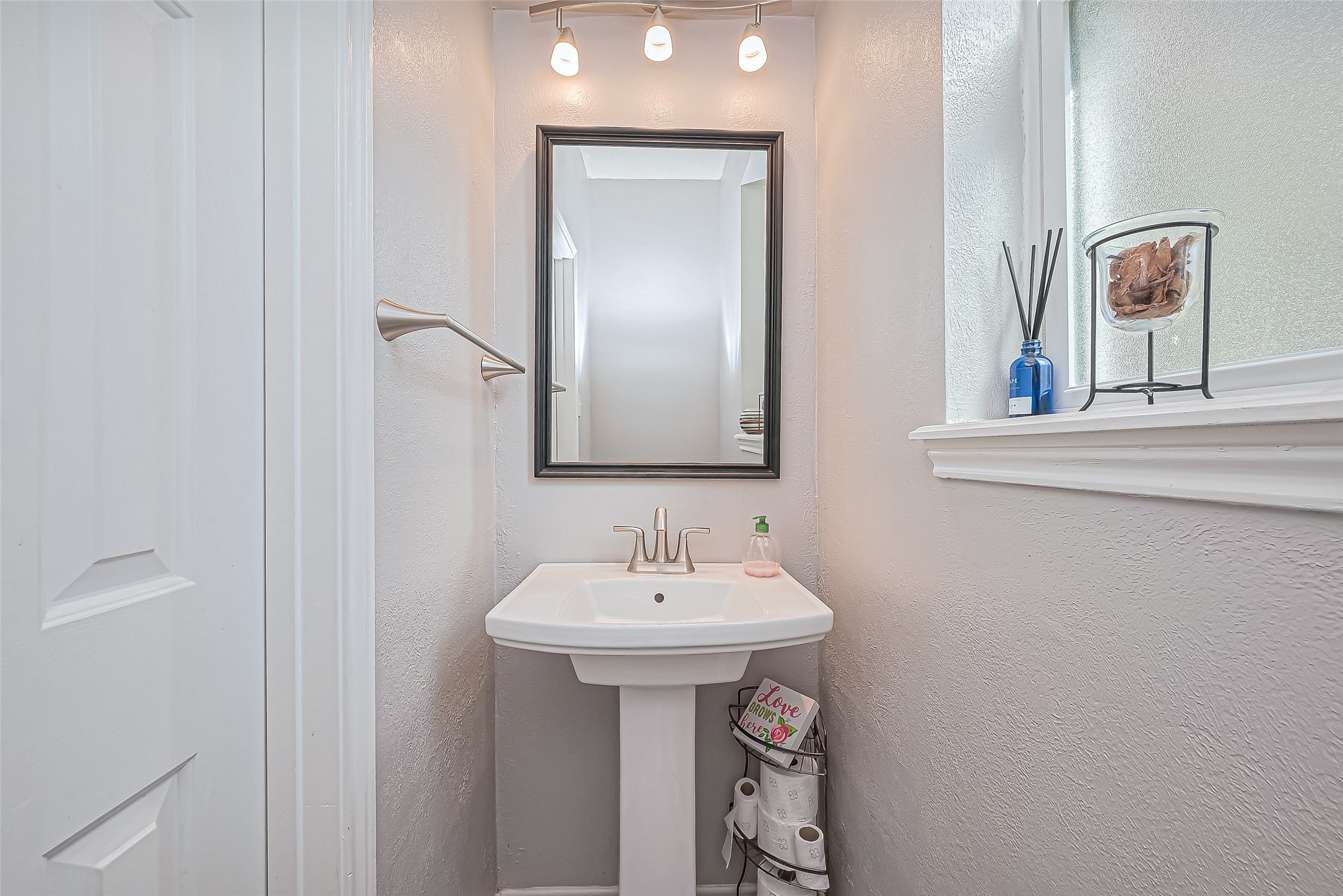 5803 Slashwood Lane Spring, TX 77379 - Photo 23 of 46 Stylish half bathroom with elegant fixtures and natural light.