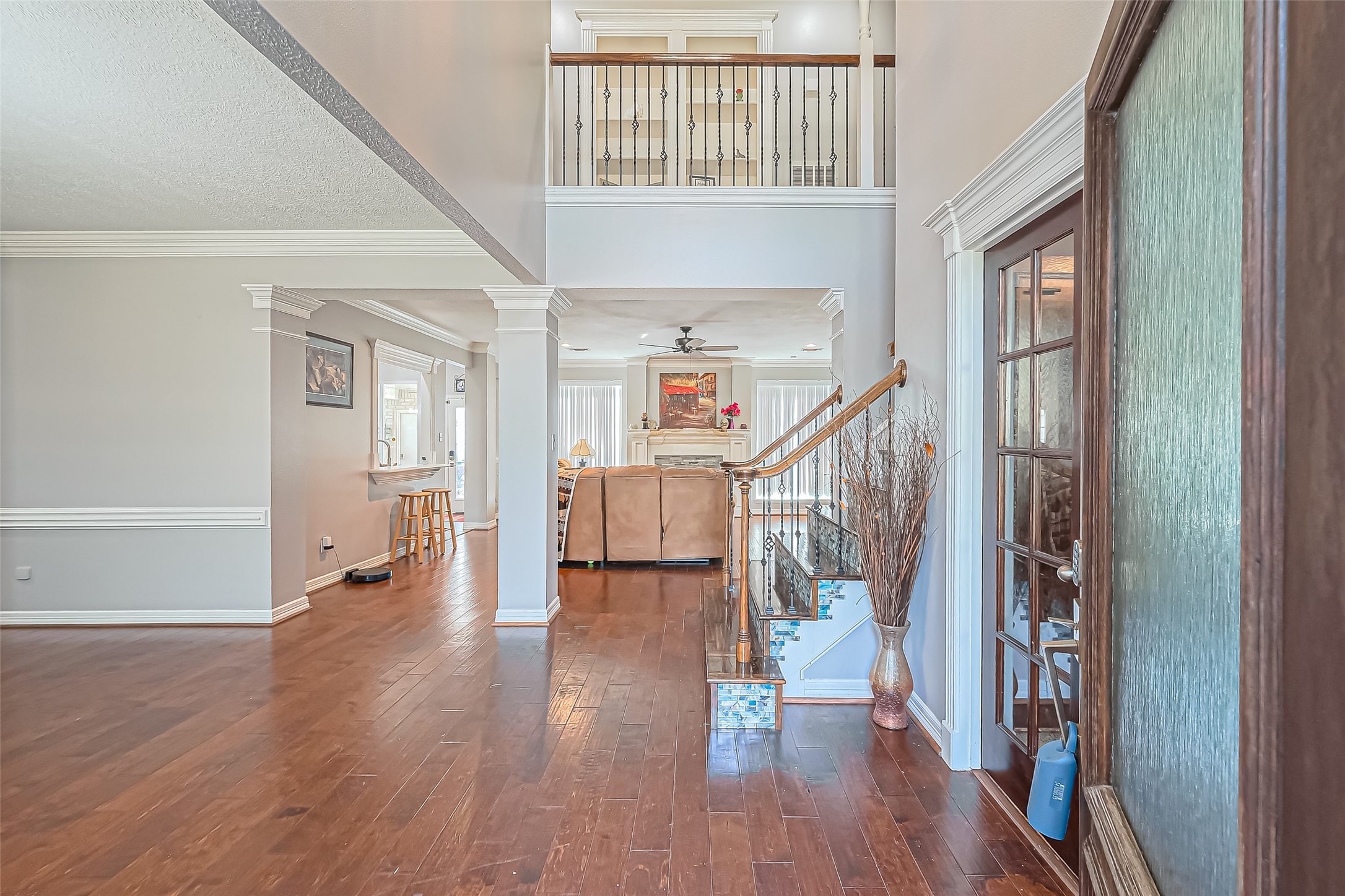 5803 Slashwood Lane Spring, TX 77379 - Photo 7 of 46 Welcome to an inviting entryway featuring elegant engineered wood floors, high ceilings, and abundant natural light, seamlessly connecting to the living and dining areas.
