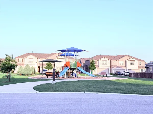 a view of multiple houses with a yard