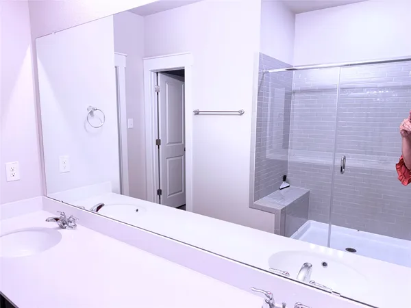 a bathroom with a tub sink and mirror
