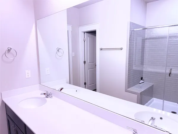 a bathroom with a tub sink and mirror