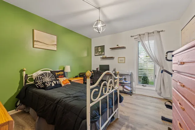 a bedroom with two beds and a window