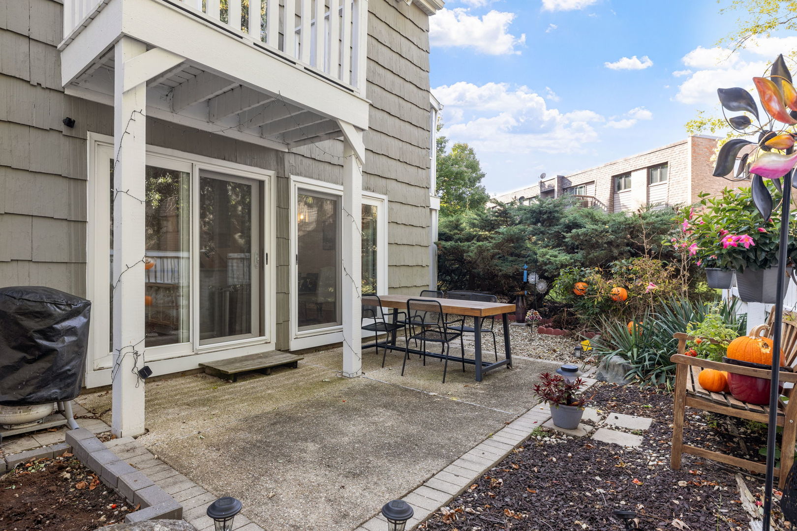 1420 Stonebridge Trail, Unit 13 Wheaton, IL 60189 - Photo 15 of 24 a view of a house with backyard sitting area and garden