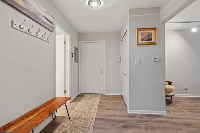 a view of hallway with wooden floor