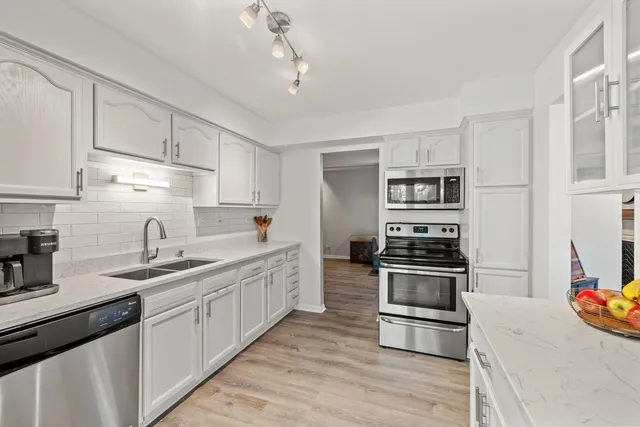 a kitchen with a sink stove and refrigerator