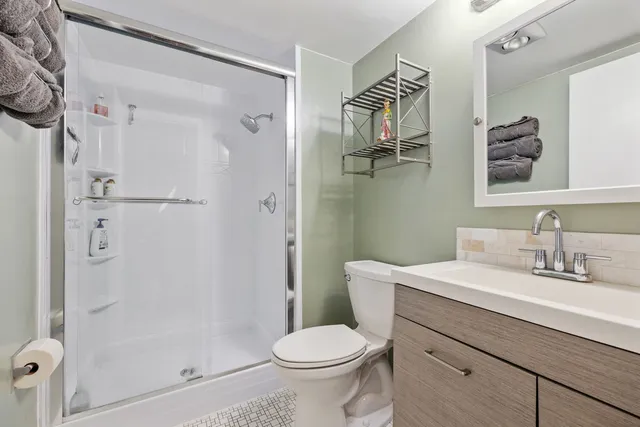 a bathroom with a sink toilet and shower
