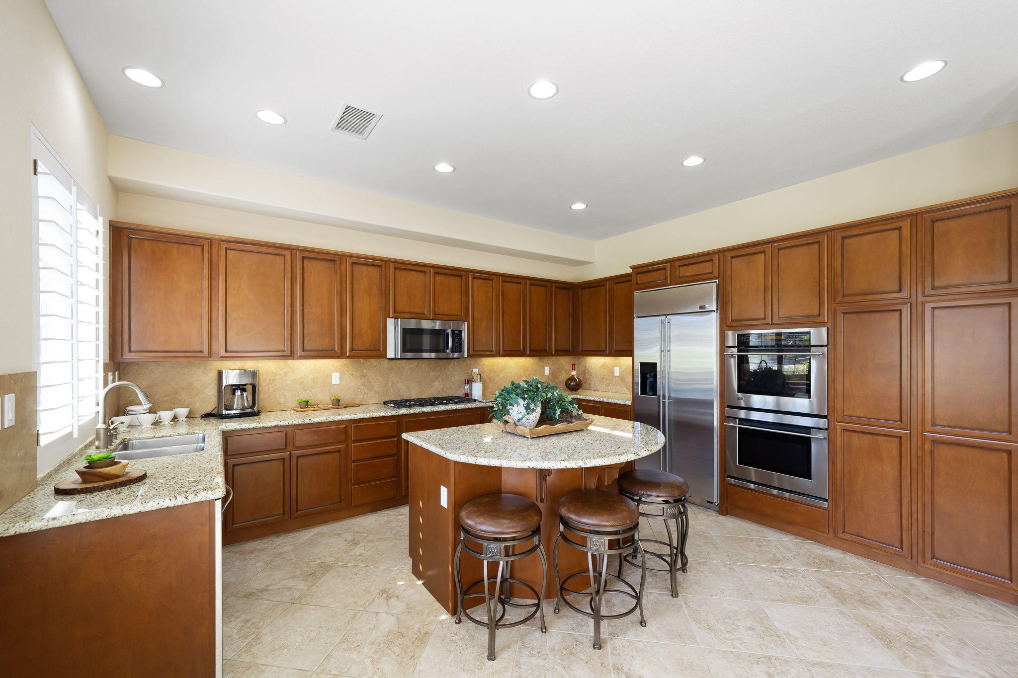 81189 Red Rock Road La Quinta, CA 92253 - Photo 12 of 85 a kitchen with a sink stainless steel appliances and view living room