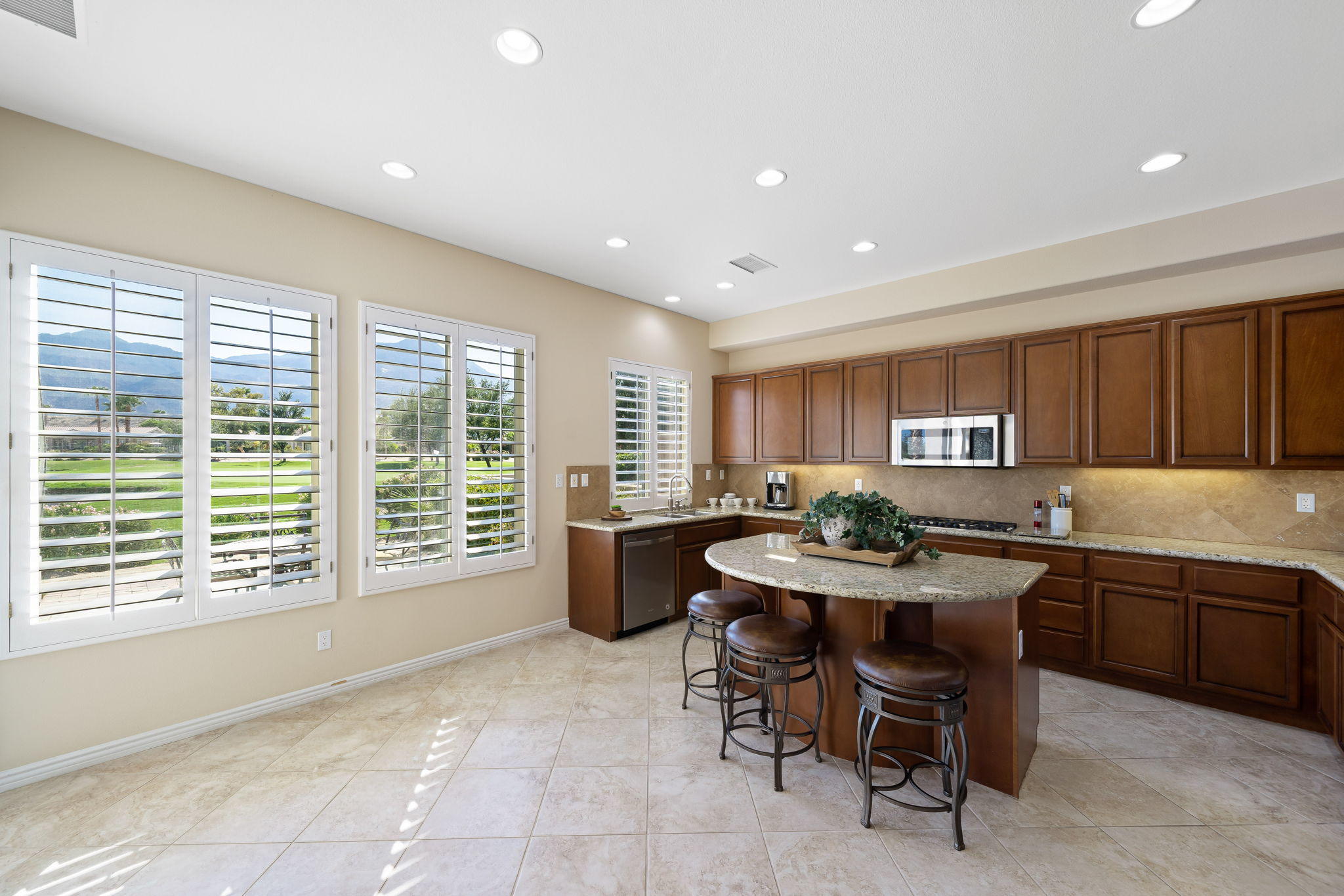 81189 Red Rock Road La Quinta, CA 92253 - Photo 15 of 85 a kitchen with a table and chairs in it