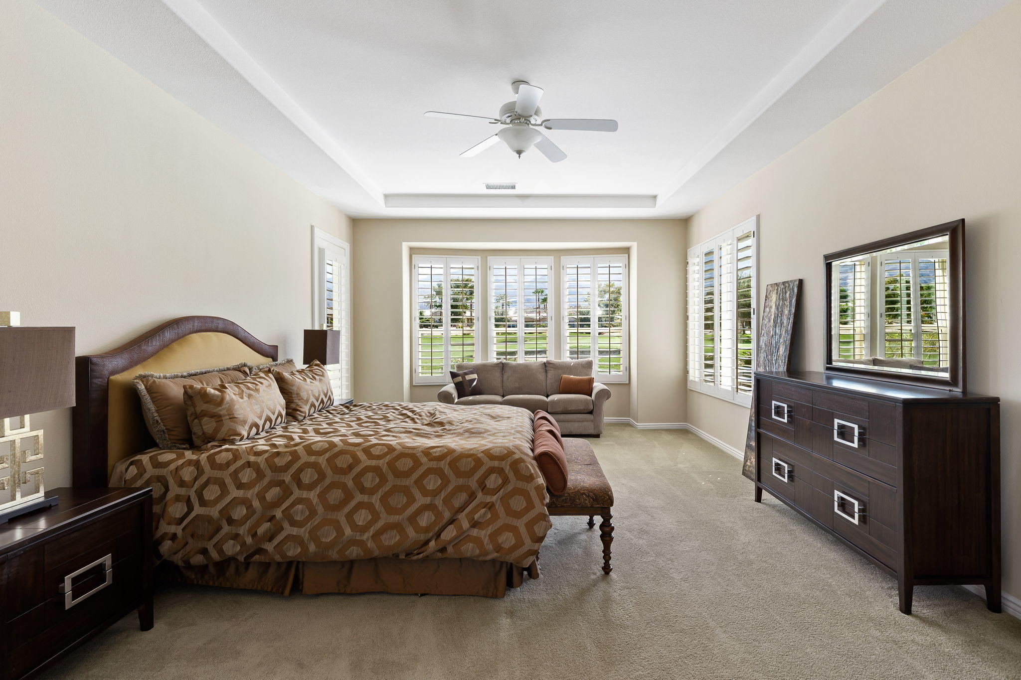 81189 Red Rock Road La Quinta, CA 92253 - Photo 20 of 85 a bedroom with a bed and a dresser next to a window