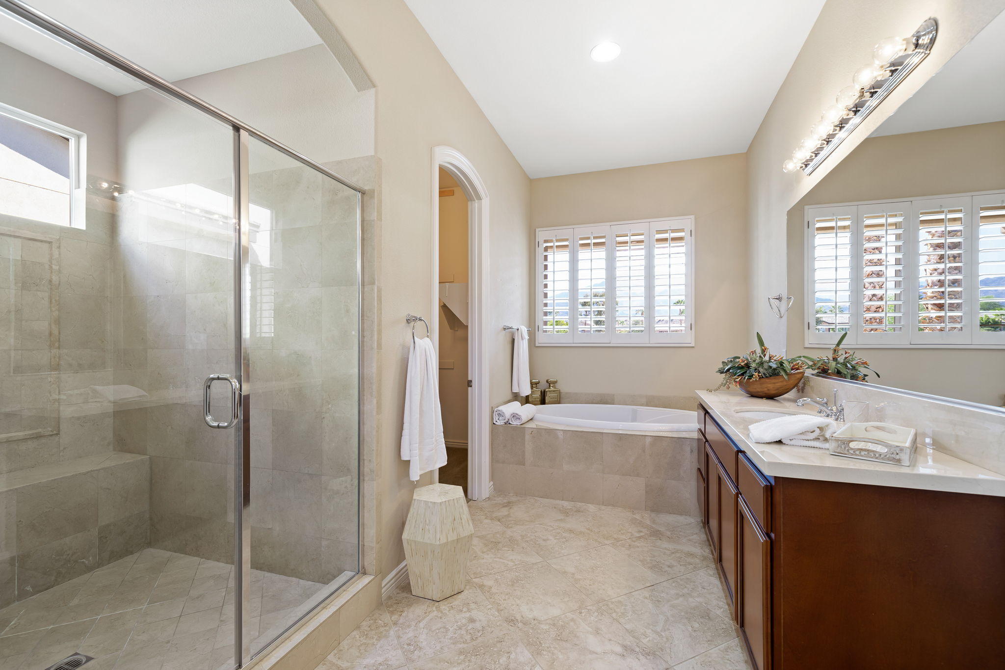 81189 Red Rock Road La Quinta, CA 92253 - Photo 23 of 85 a spacious bathroom with a tub sink shower and mirror