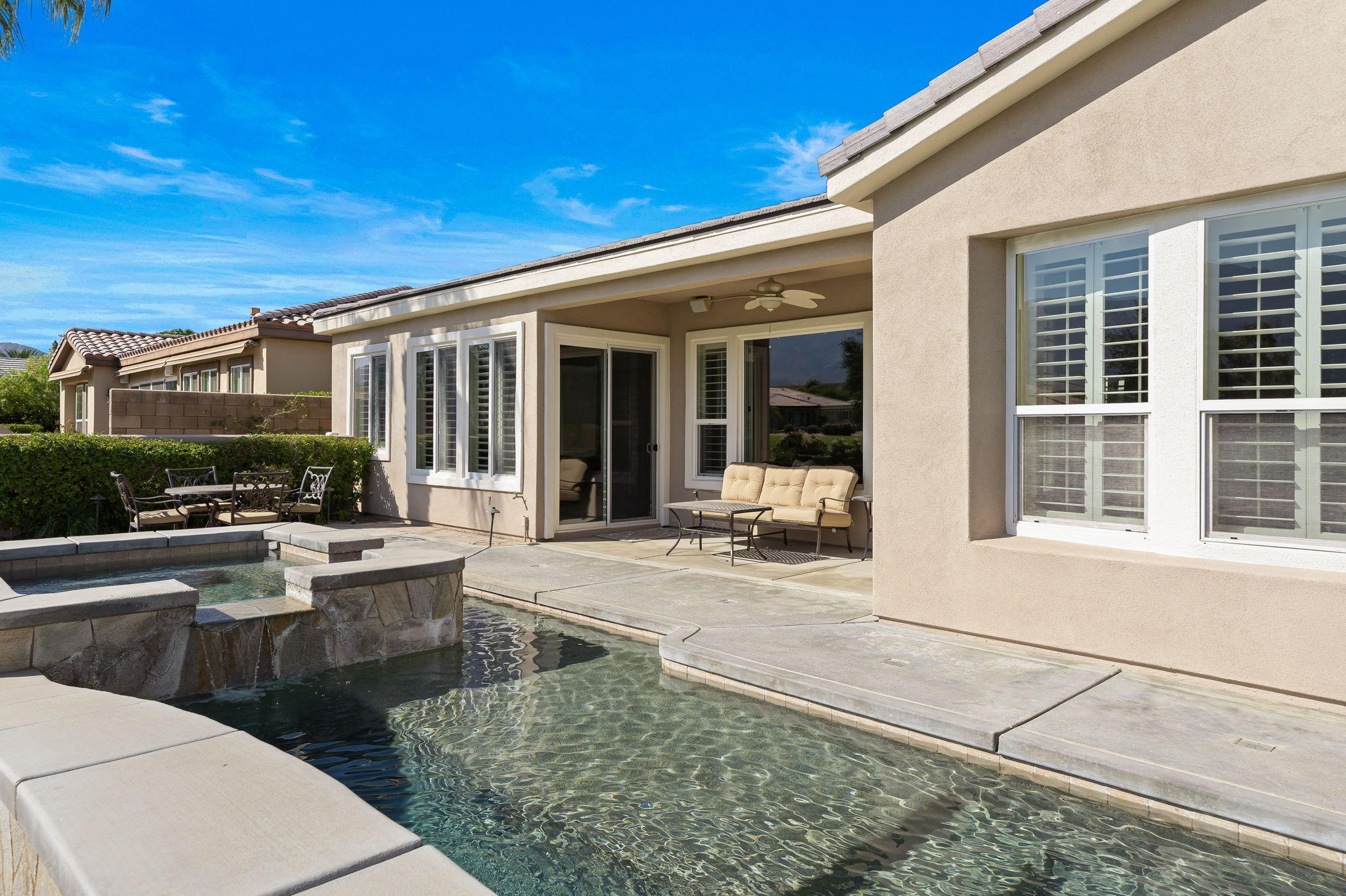 81189 Red Rock Road La Quinta, CA 92253 - Photo 34 of 85 a view of a patio with couches table and chairs and potted plants