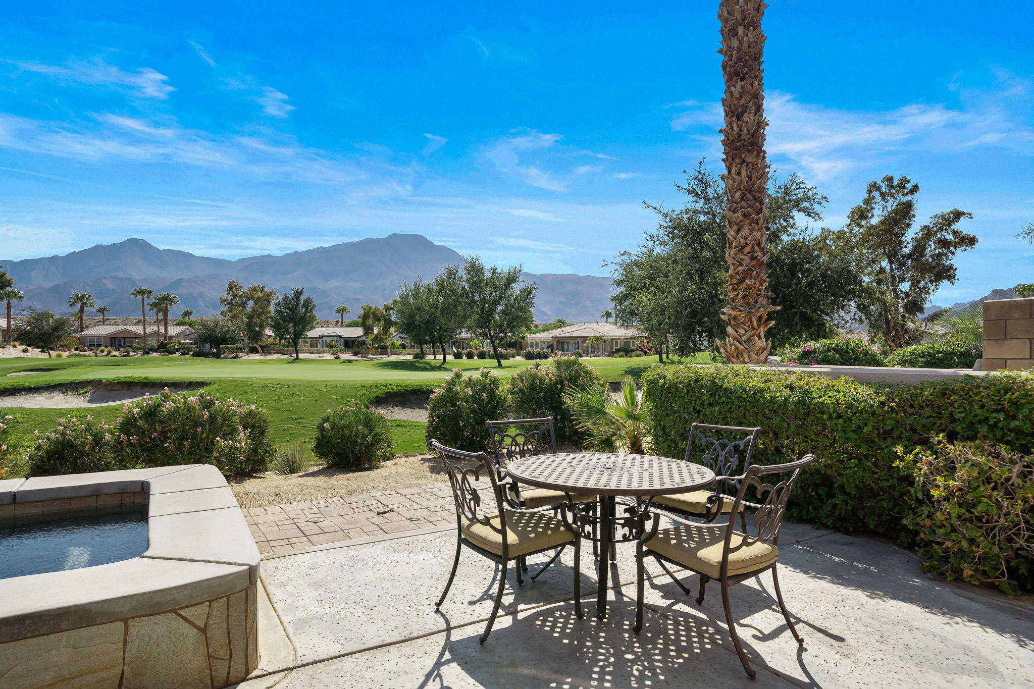 81189 Red Rock Road La Quinta, CA 92253 - Photo 36 of 85 a view of a patio with a table chairs and a fire pit