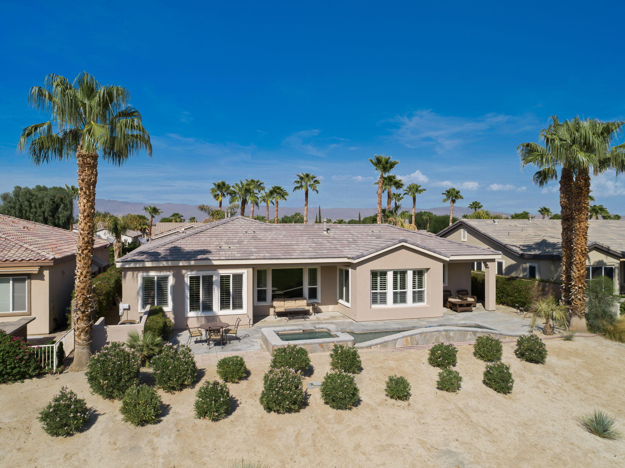 81189 Red Rock Road La Quinta, CA 92253 - Photo 39 of 85 a front view of a house with a garden