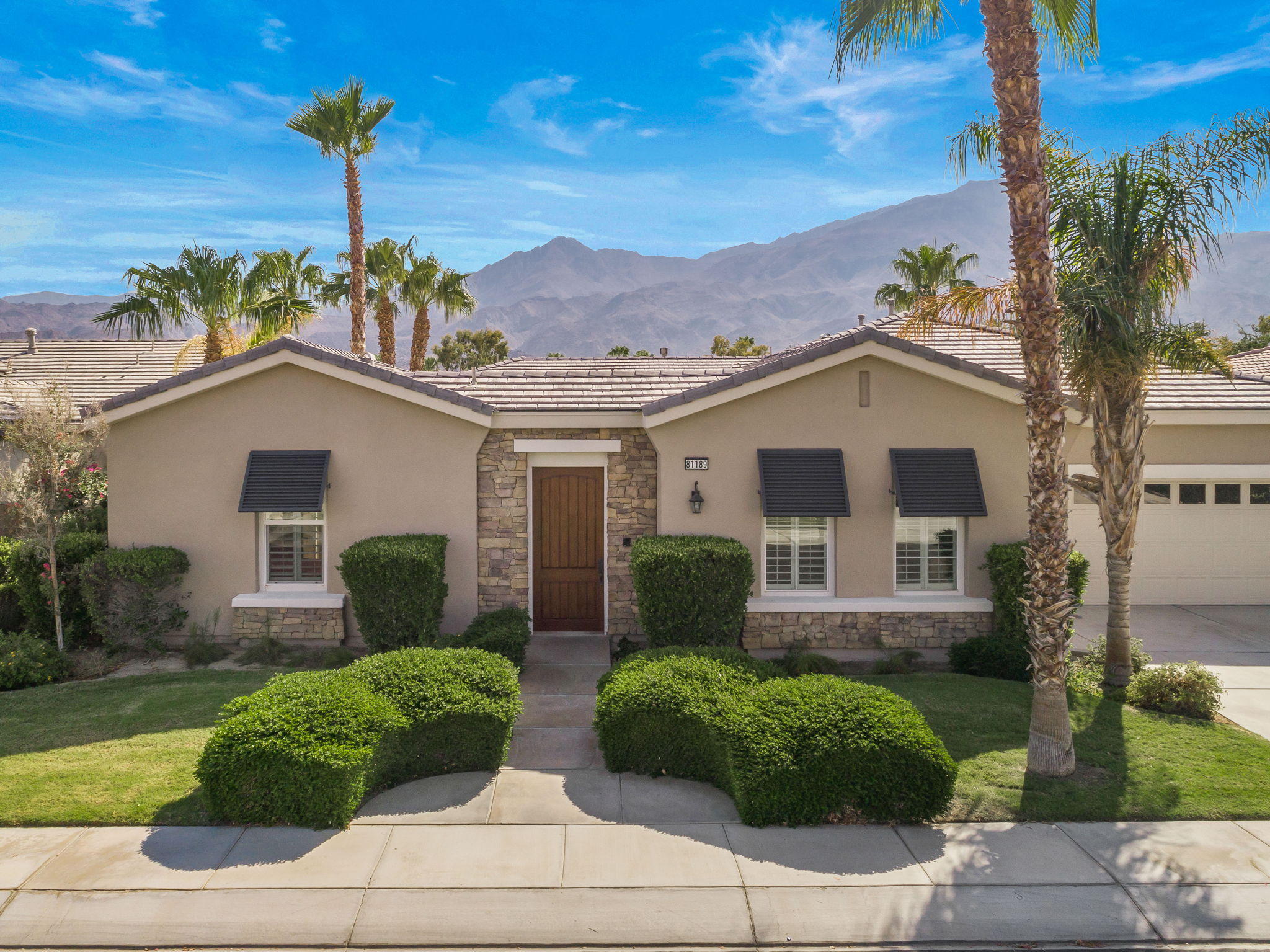 81189 Red Rock Road La Quinta, CA 92253 - Photo 40 of 85 a front view of a house with garden