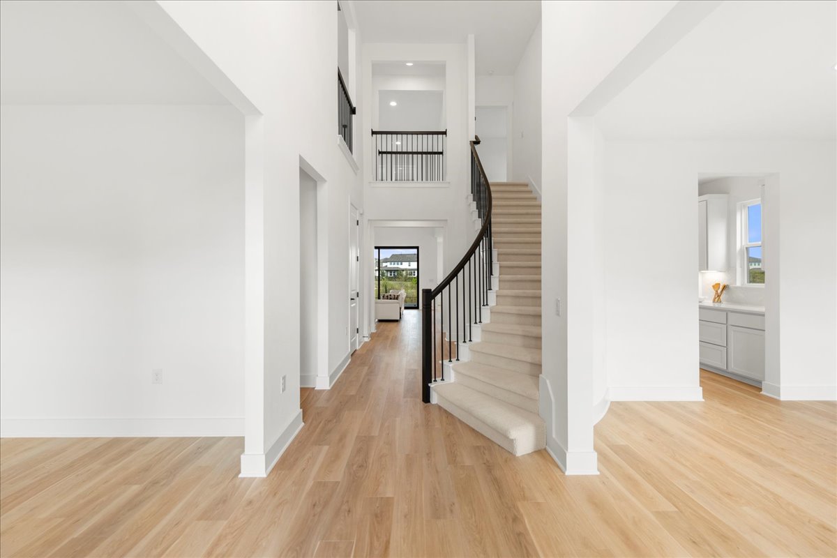 8700 Olmsted Way Austin, TX 78744 - Photo 8 of 40 Foyer featuring a high ceiling, light wood finished floors, and stairs