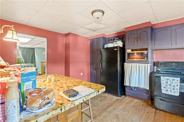 a kitchen with granite countertop wooden cabinets and stainless steel appliances