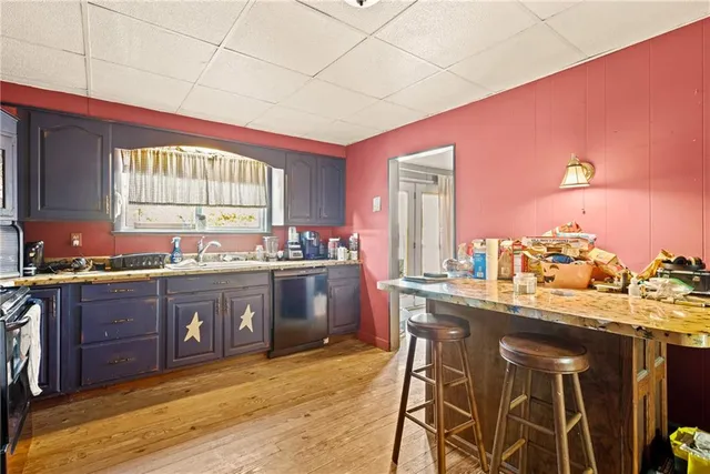 a kitchen with stainless steel appliances granite countertop a refrigerator a sink a stove and island