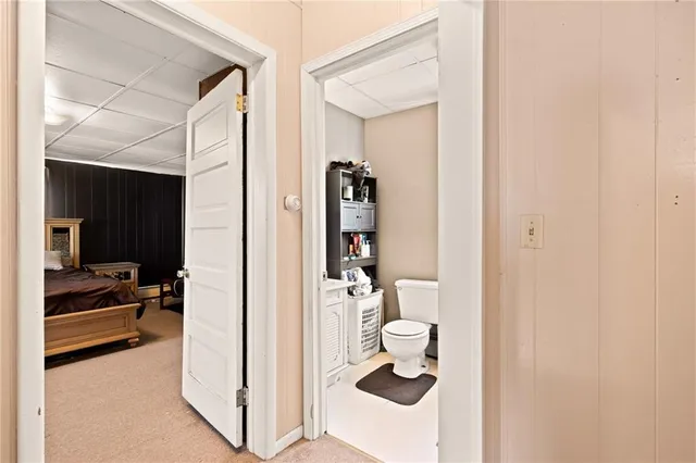 a spacious bedroom with a bed and a chandelier