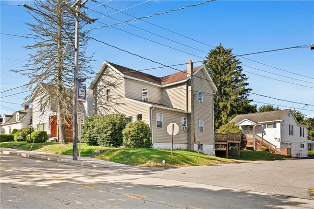a front view of a building with tree s