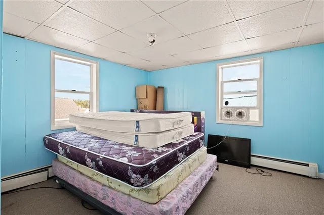 a bedroom with furniture and a window