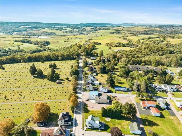 an aerial view of residential houses with outdoor space