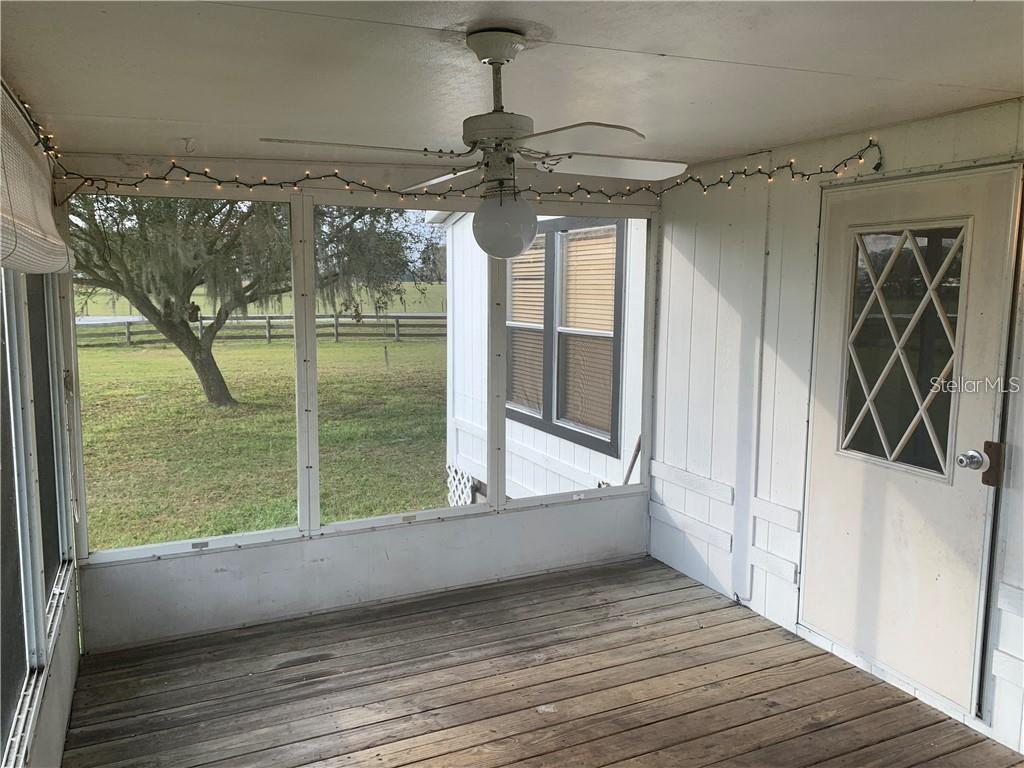 8719 Lithia Pinecrest Road Lithia, FL 33547 - Photo 19 of 21 a view of a room with wooden floor and outdoor space