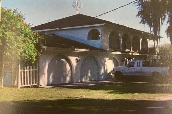 a view of a house with backyard porch and sitting area