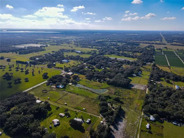 an aerial view of a house with a lake view