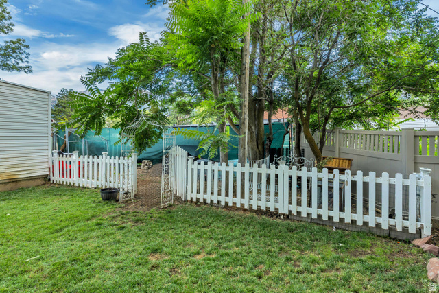 1215 8th Street Ogden, UT 84404 - Photo 38 of 39 Expansive lawn area featuring a classic white picket fence with an arched gate