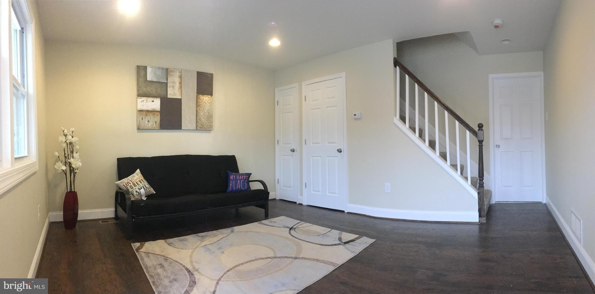 8030 Gray Haven Road Baltimore, MD 21222 - Photo 2 of 30 a living room with furniture and a fireplace