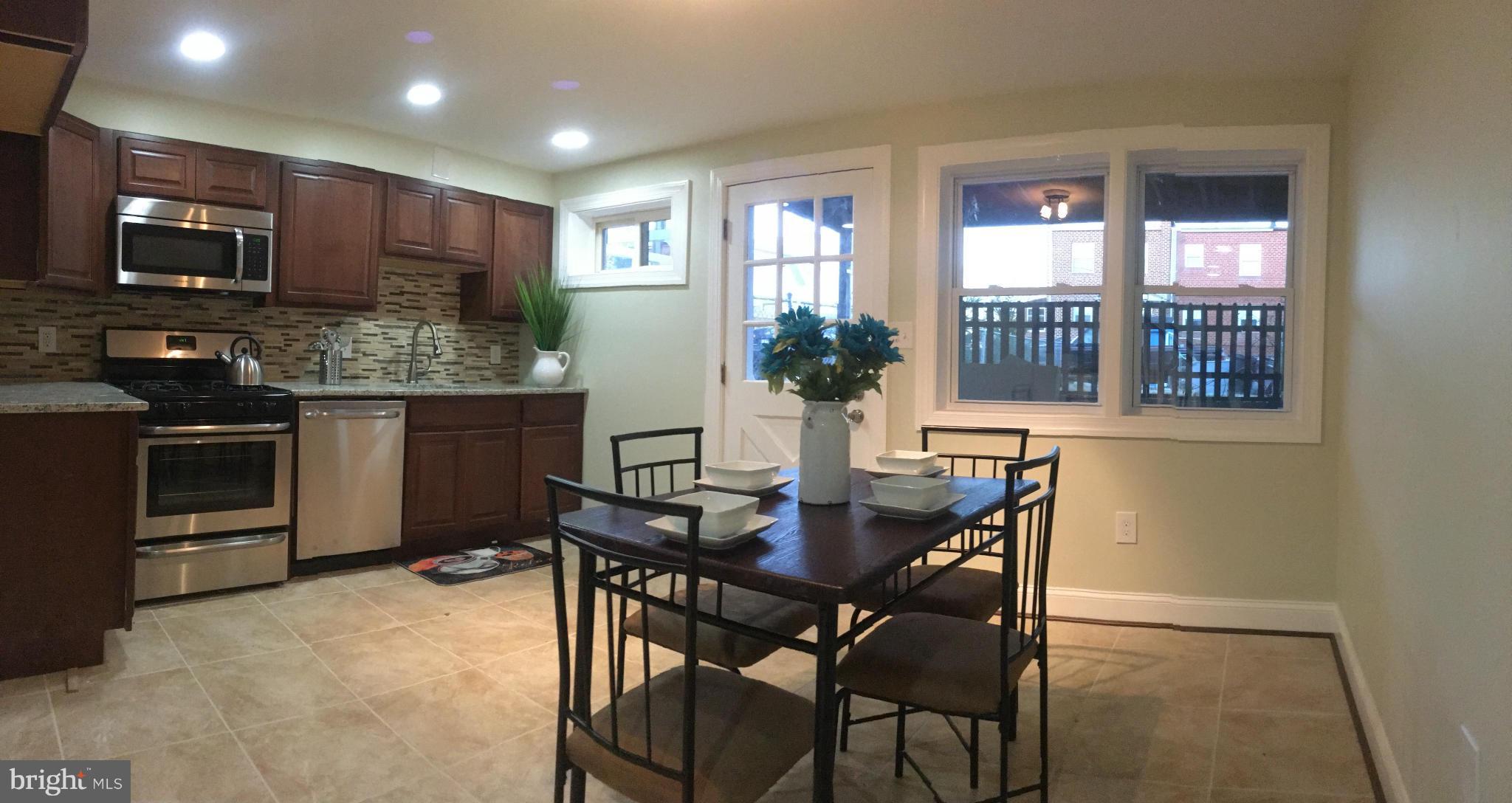 8030 Gray Haven Road Baltimore, MD 21222 - Photo 11 of 30 a kitchen with a table and chairs in it