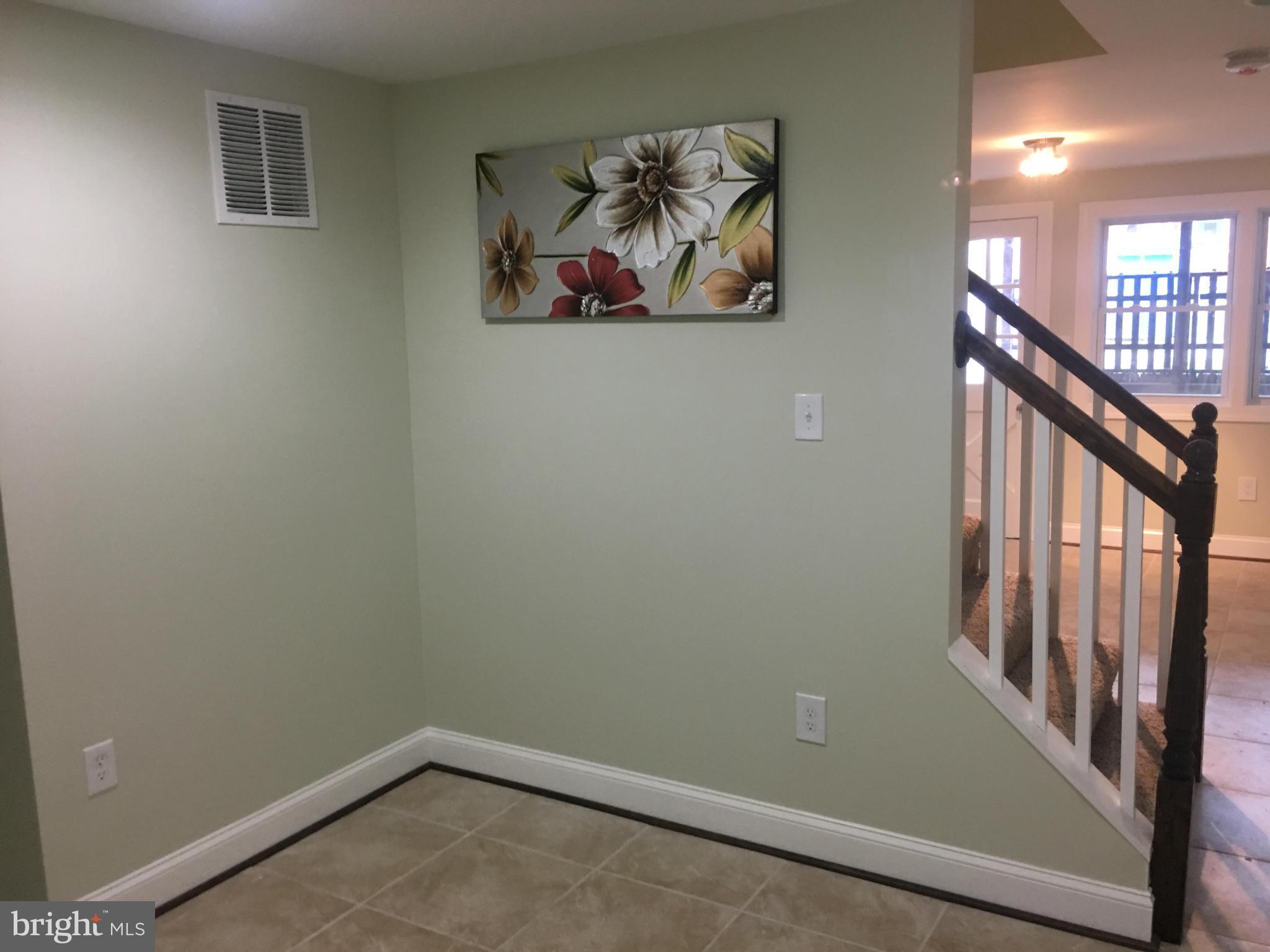 8030 Gray Haven Road Baltimore, MD 21222 - Photo 14 of 30 a view of a hallway with paintings on the wall