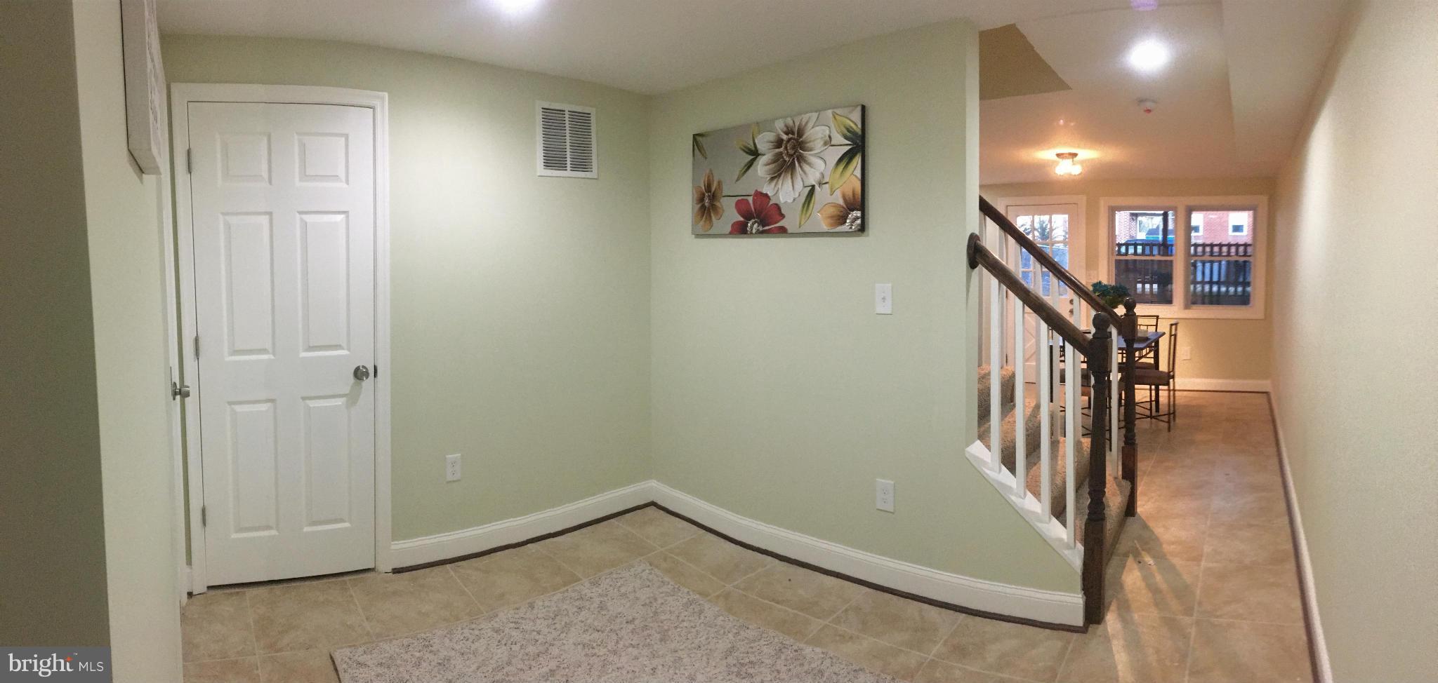8030 Gray Haven Road Baltimore, MD 21222 - Photo 15 of 30 a view of a hallway with paintings on the wall