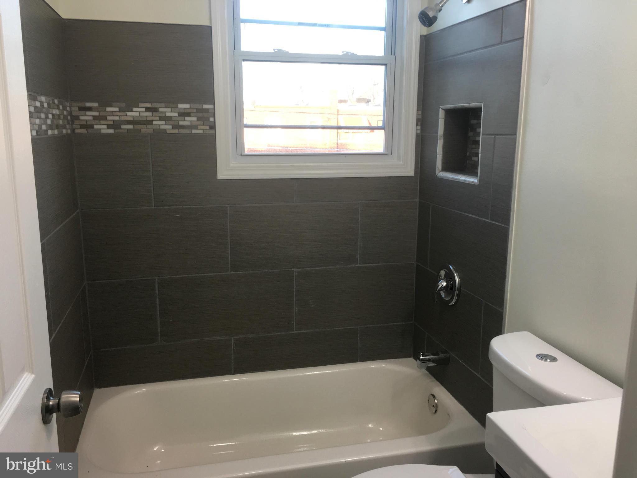 8030 Gray Haven Road Baltimore, MD 21222 - Photo 17 of 30 a bathroom with a tub and a window