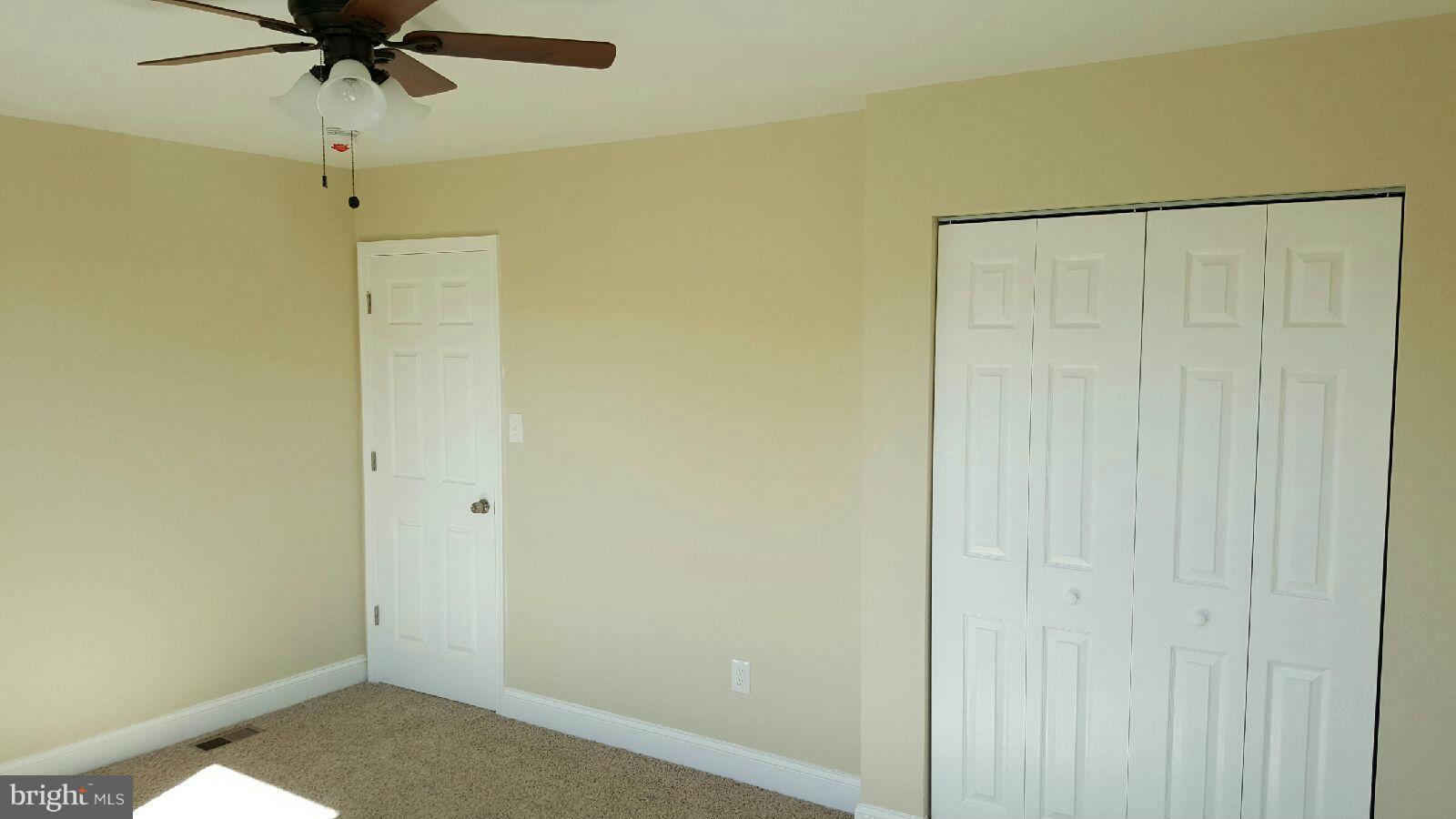 8030 Gray Haven Road Baltimore, MD 21222 - Photo 25 of 30 a view of a room with a ceiling fan and a window