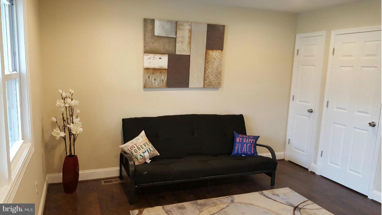 8030 Gray Haven Road Baltimore, MD 21222 - Photo 4 of 30 a living room with furniture and a wooden floor