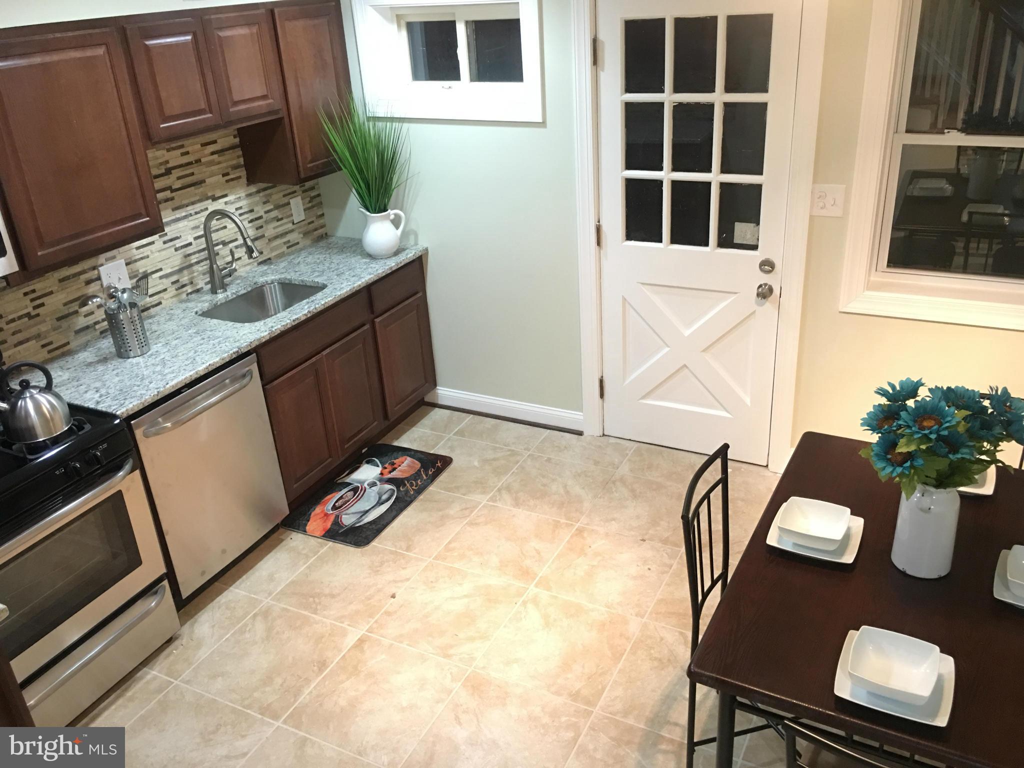 8030 Gray Haven Road Baltimore, MD 21222 - Photo 6 of 30 a view of a kitchen area with furniture and wooden floor