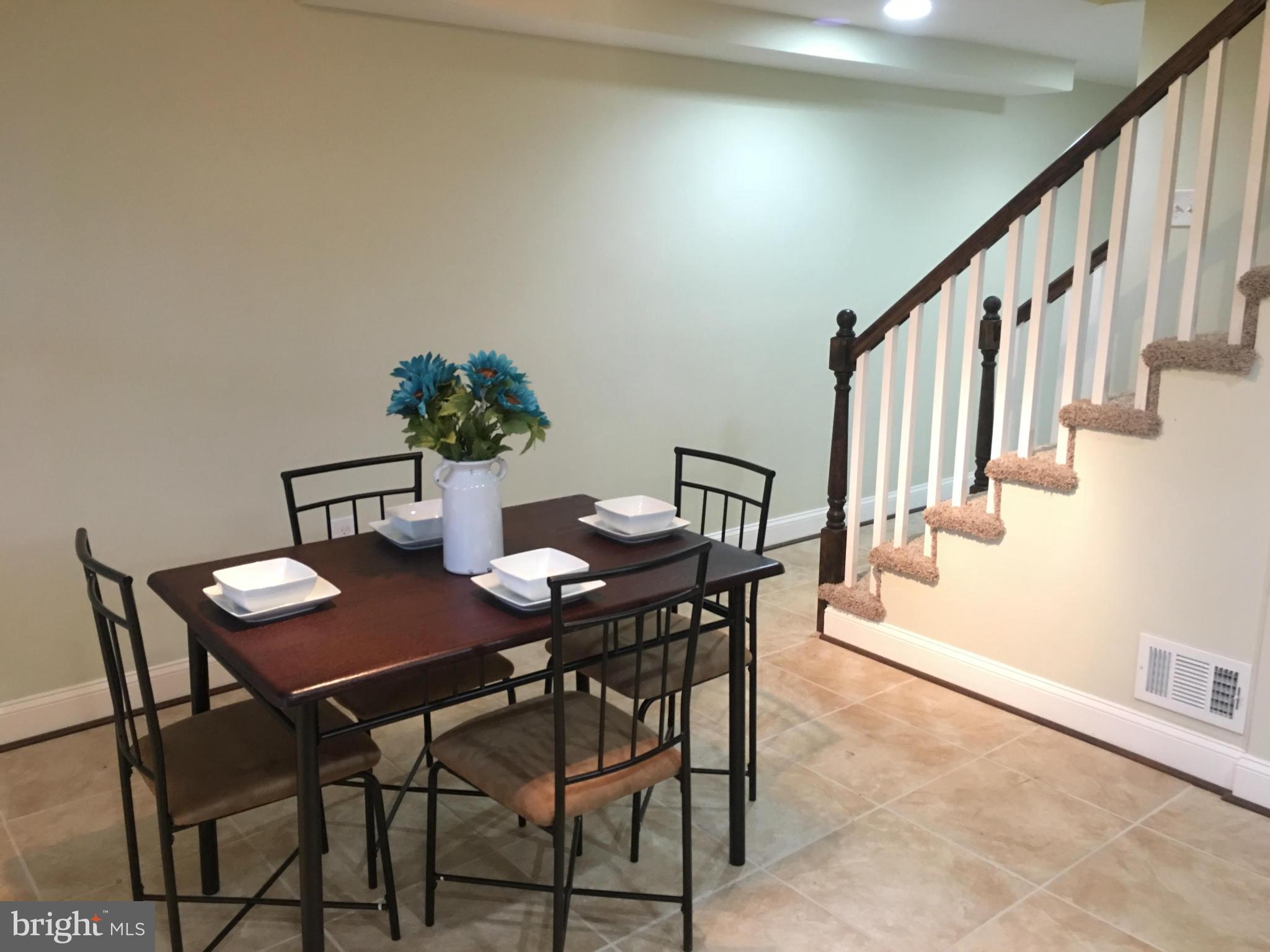 8030 Gray Haven Road Baltimore, MD 21222 - Photo 9 of 30 a view of a dining room with furniture and wooden floor