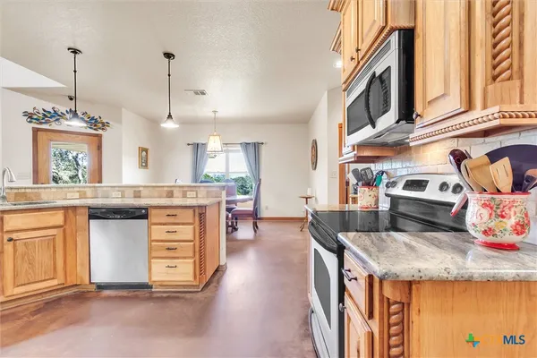 a kitchen with sink and stove