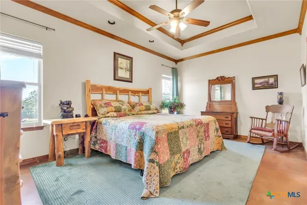 a spacious bedroom with a bed and a chandelier