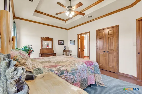 a bedroom with a large bed and a chandelier