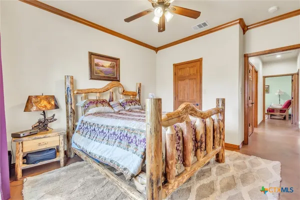 a bedroom with a bed and a chandelier
