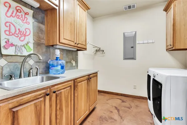 a kitchen with stainless steel appliances granite countertop a sink and a microwave oven next to a window