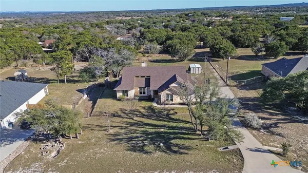 an aerial view of a house with a yard