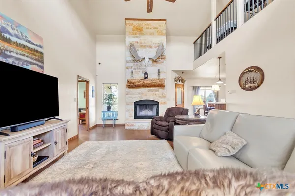 a living room with furniture a fireplace and a flat screen tv