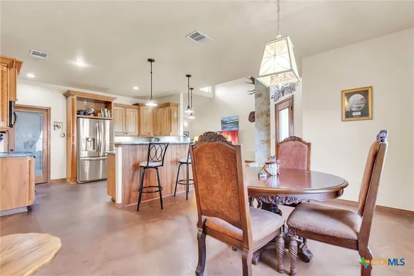 a dining room with furniture and a chandelier